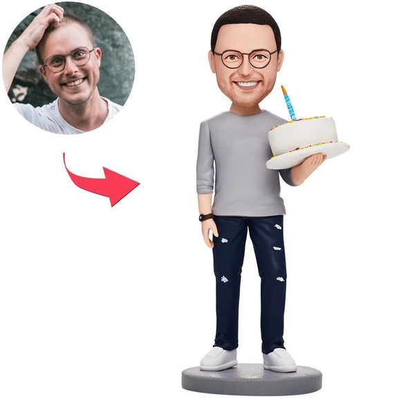 Man holding a custom Bobblehead birthday cake with text engraved