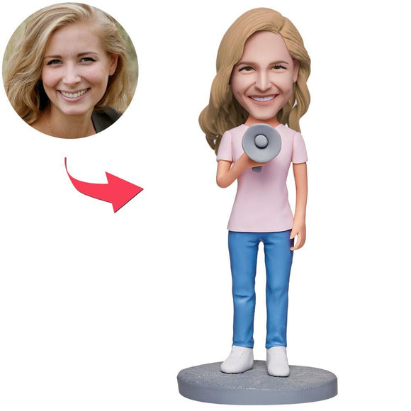 Female holding a custom embroidered speaker with text engraved Bobblehead